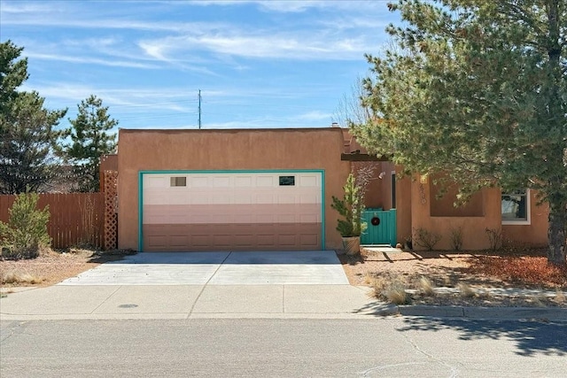 garage with fence and driveway