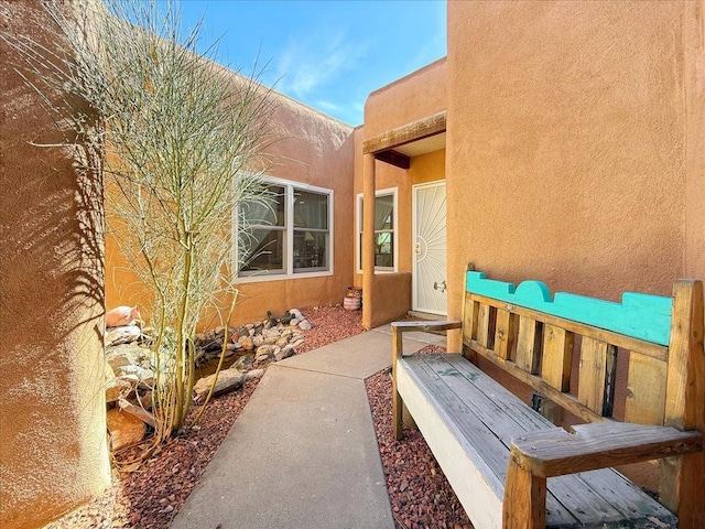 property entrance with stucco siding