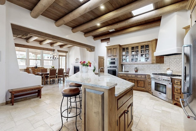 kitchen with wood ceiling, custom exhaust hood, decorative backsplash, appliances with stainless steel finishes, and brown cabinetry