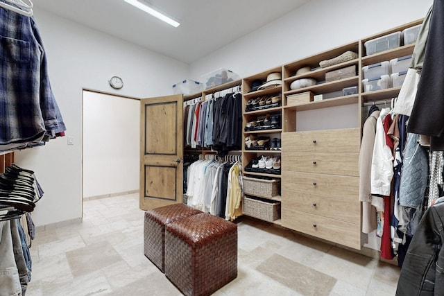 spacious closet with stone finish floor