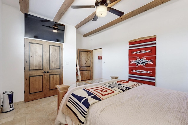 bedroom with vaulted ceiling with beams and ceiling fan