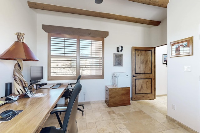 office space featuring beam ceiling, stone tile floors, and baseboards