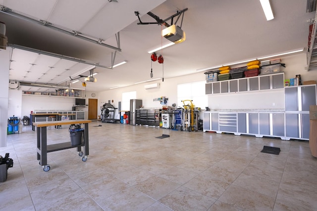 garage with a workshop area, a garage door opener, and a wall mounted air conditioner