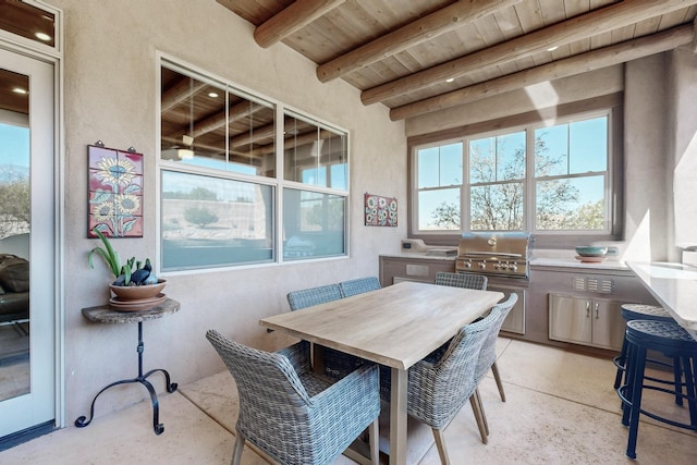 dining space featuring beam ceiling and wood ceiling