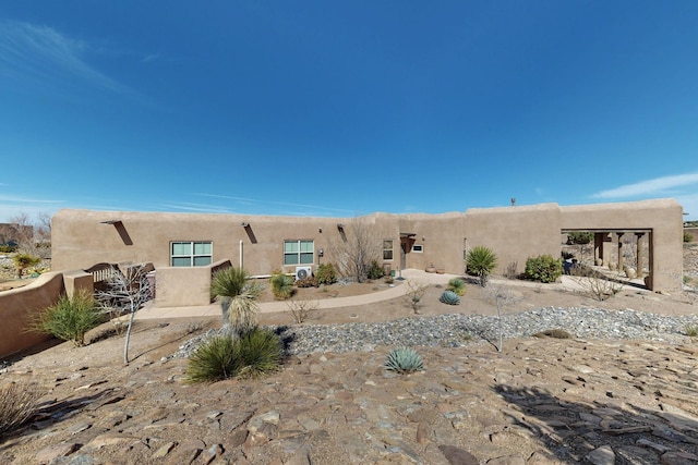 back of house with stucco siding