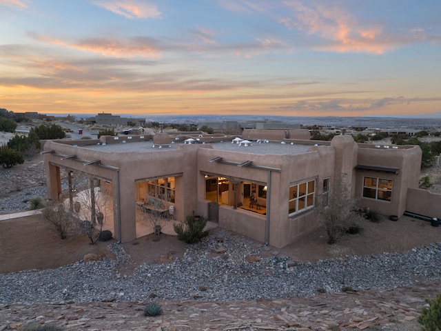 rear view of house with stucco siding