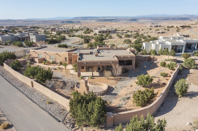 birds eye view of property with view of desert, a mountain view, and a residential view