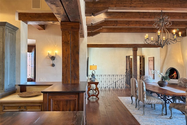 dining space with beamed ceiling, dark wood-style flooring, ornate columns, and a chandelier