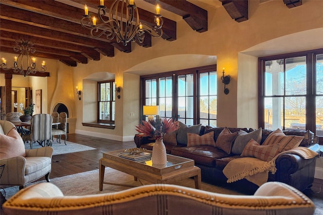 living room featuring baseboards, beam ceiling, french doors, wood-type flooring, and a chandelier