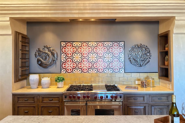 kitchen with backsplash, light countertops, and range with two ovens