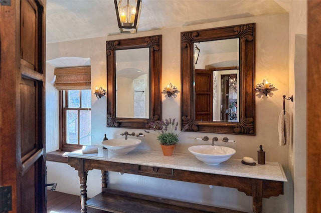 full bathroom featuring a sink and double vanity