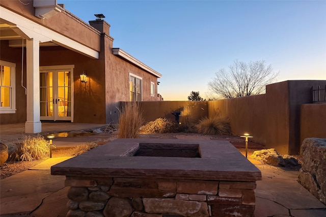 view of storm shelter featuring a patio area and fence