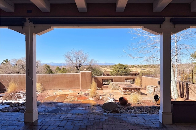 view of patio / terrace featuring an outdoor fire pit and fence