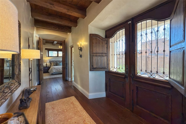 entryway with dark wood-type flooring, beamed ceiling, french doors, and baseboards