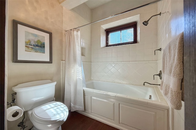 full bath featuring toilet, wood finished floors, and shower / tub combo