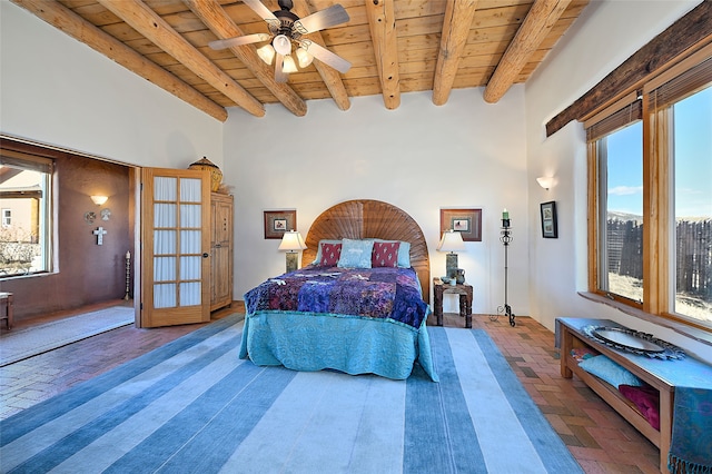 bedroom with beam ceiling, wooden ceiling, and brick floor