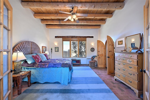 bedroom with brick floor, beam ceiling, and wooden ceiling