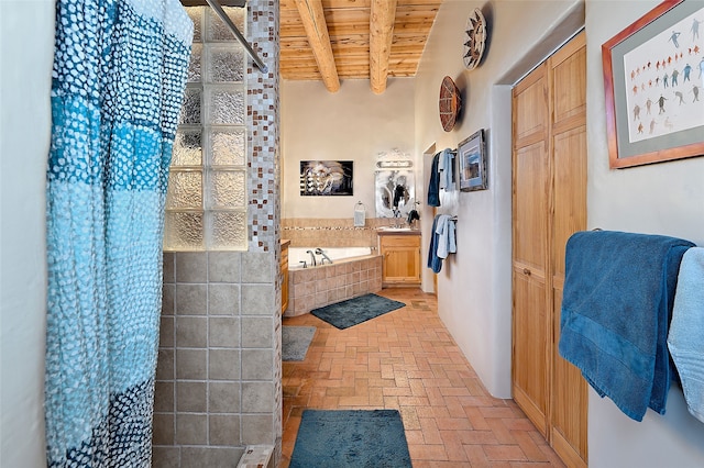 full bathroom featuring beamed ceiling, wood ceiling, a tile shower, brick floor, and a bath