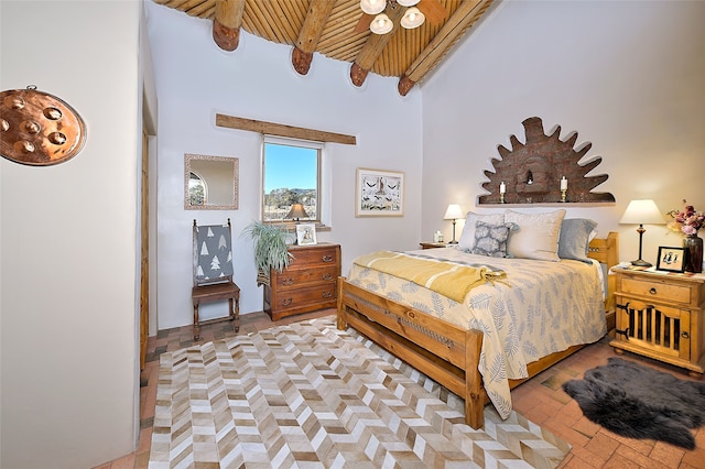 bedroom with beamed ceiling, wooden ceiling, brick floor, and a towering ceiling