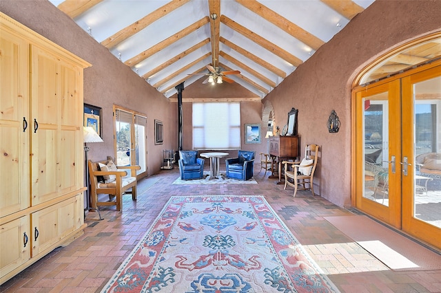 interior space featuring french doors, vaulted ceiling with beams, and a wood stove