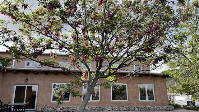 view of home's exterior with stucco siding and a tile roof