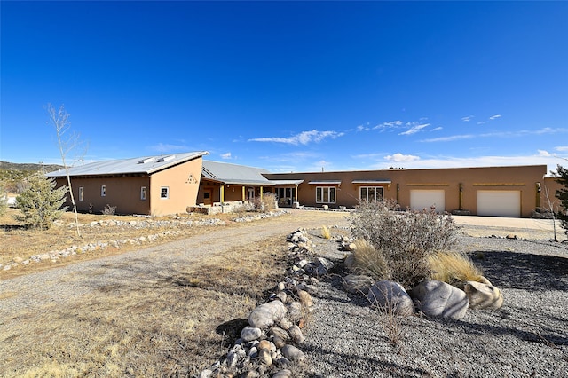 view of front of house with stucco siding and an attached garage