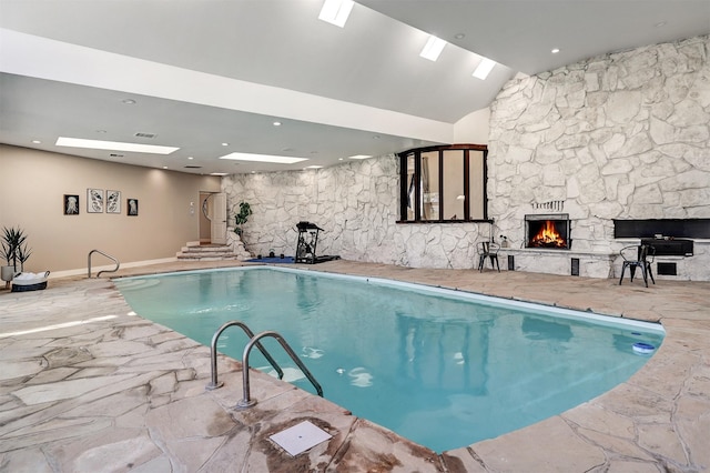 indoor pool featuring a fireplace