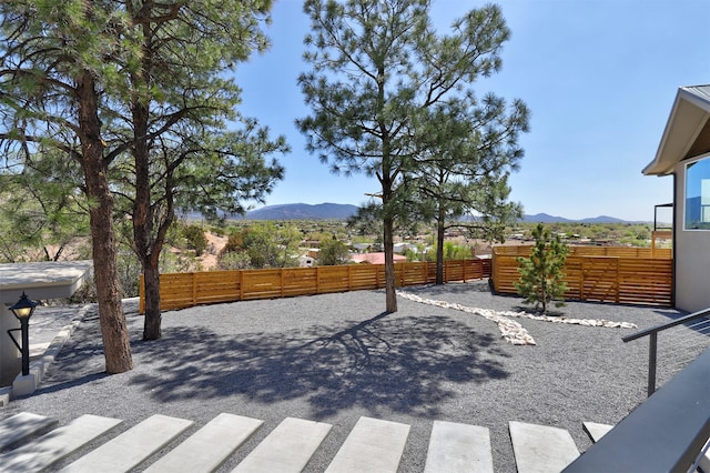 view of patio / terrace featuring a mountain view and fence