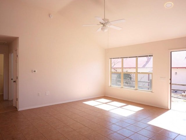 empty room with baseboards, tile patterned floors, high vaulted ceiling, and a ceiling fan