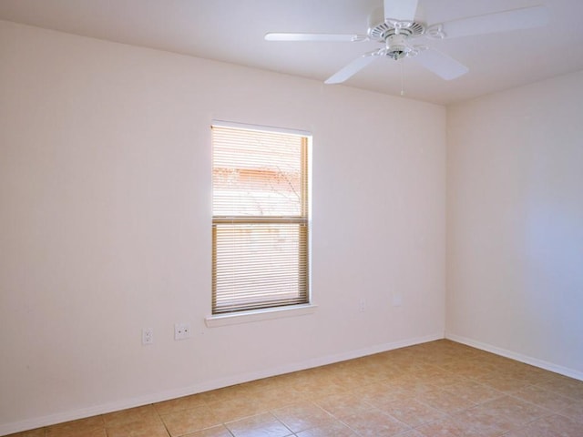 unfurnished room featuring baseboards and a ceiling fan