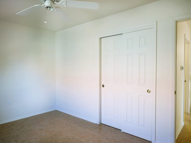 unfurnished bedroom featuring a closet, baseboards, and ceiling fan