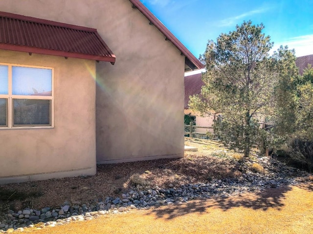 view of side of home with stucco siding