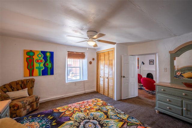 carpeted bedroom featuring a ceiling fan, a closet, and baseboards