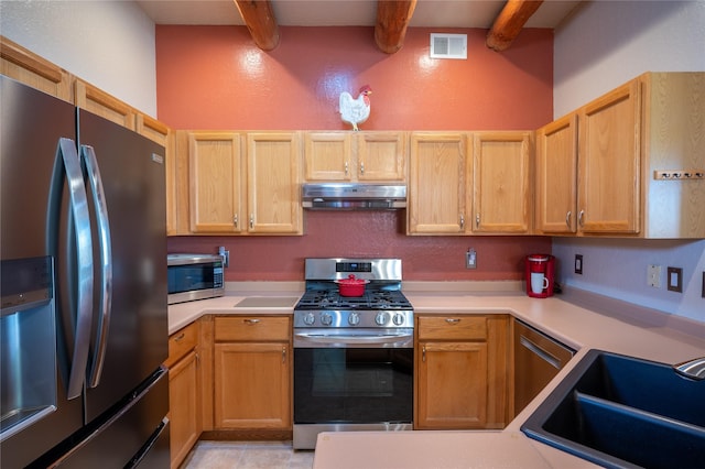 kitchen with visible vents, under cabinet range hood, beam ceiling, appliances with stainless steel finishes, and a sink