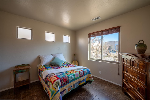 bedroom with visible vents and baseboards