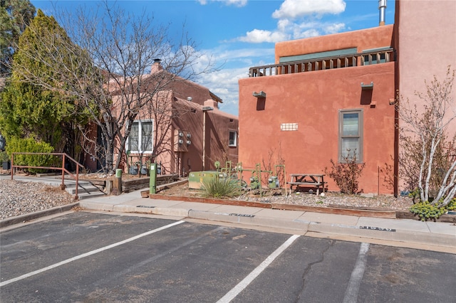 view of building exterior with uncovered parking