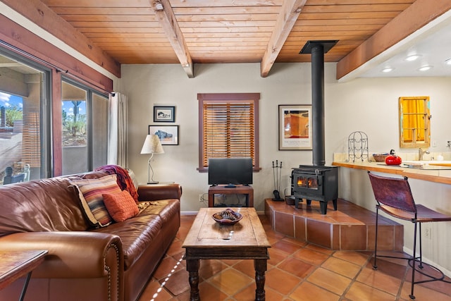 tiled living room with recessed lighting, beamed ceiling, wood ceiling, and a wood stove