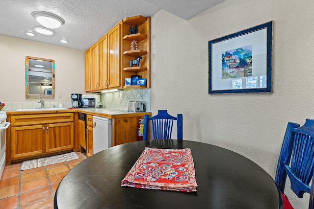 kitchen featuring a sink, backsplash, dishwasher, light tile patterned flooring, and open shelves