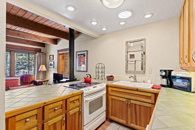 living area featuring beam ceiling, light tile patterned floors, wooden ceiling, and a wood stove