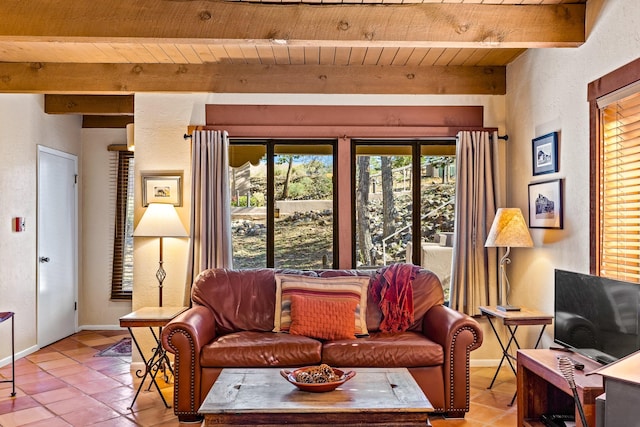 living room featuring beam ceiling, light tile patterned floors, baseboards, and wooden ceiling