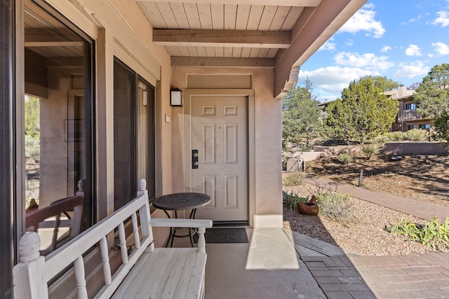 entrance to property featuring stucco siding