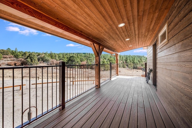 wooden terrace with a view of trees