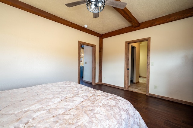 unfurnished bedroom featuring beamed ceiling, baseboards, a textured ceiling, and wood finished floors