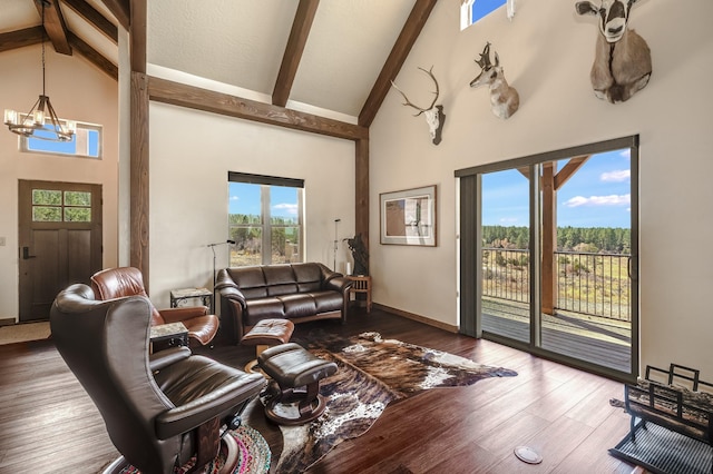 living area featuring beam ceiling, a notable chandelier, wood finished floors, and high vaulted ceiling