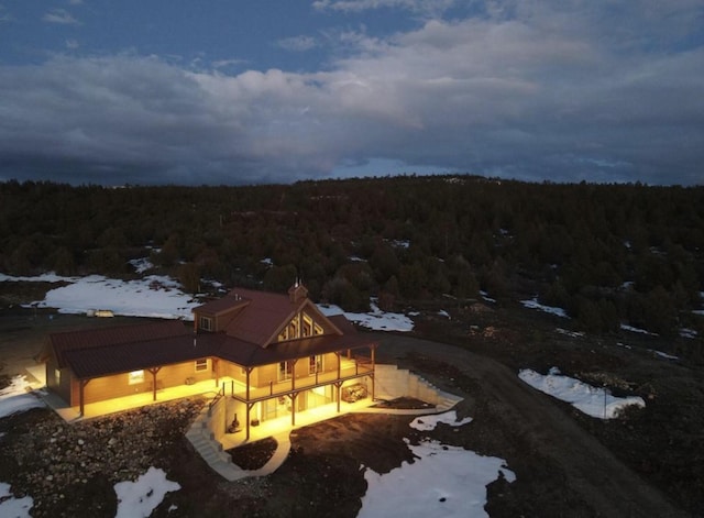 drone / aerial view featuring a wooded view