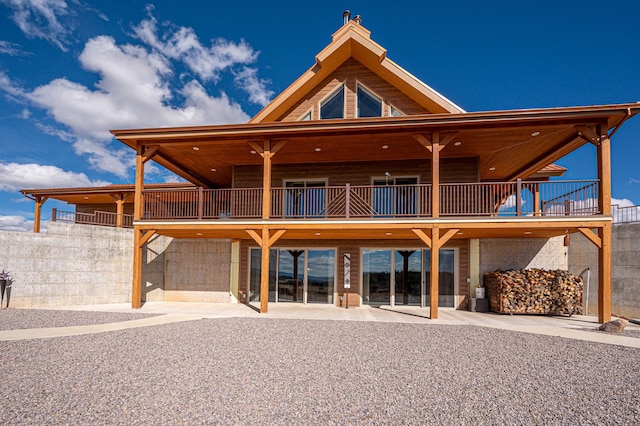 back of property with a patio and a chimney