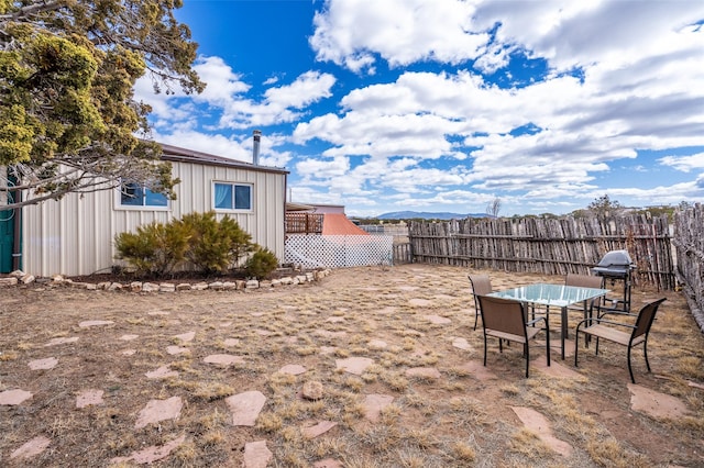 view of yard featuring outdoor dining area and a fenced backyard