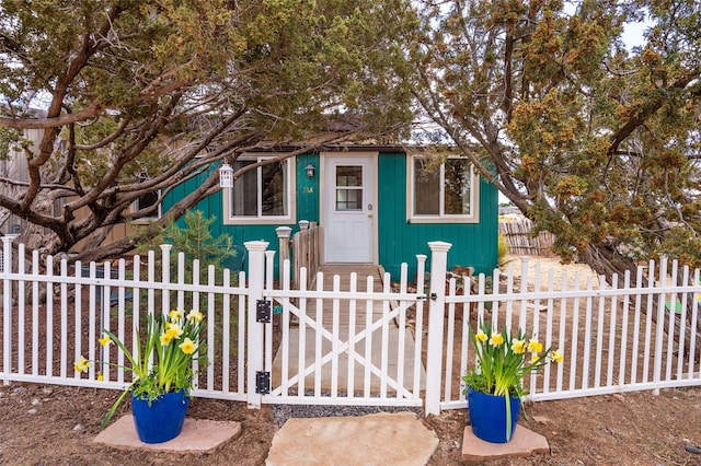 exterior space with a fenced front yard and a gate