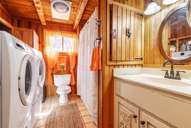 laundry room with visible vents, laundry area, a sink, wood walls, and wooden ceiling