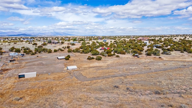 aerial view featuring a desert view and a mountain view